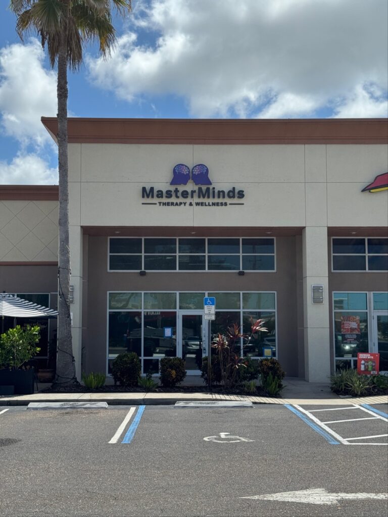 Storefront for MasterMinds Therapy & Wellness with a logo featuring two brain silhouettes above the business name.