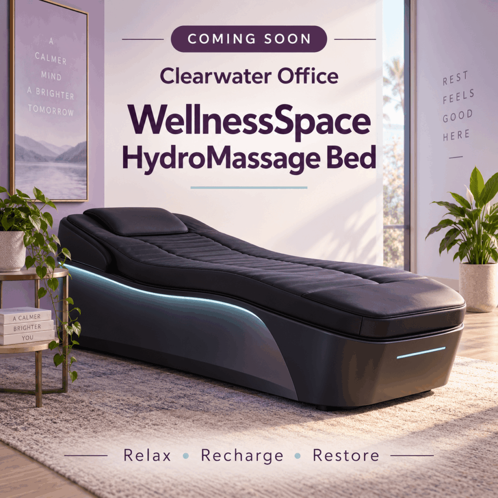 A black HydroMassage bed in a spa-like office, with text announcing that the Clearwater Office WellnessSpace is coming soon.